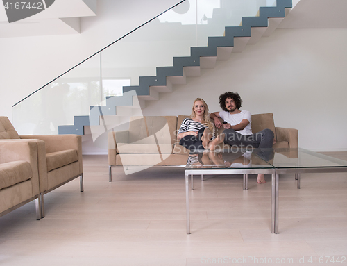 Image of Young couple on the sofa watching television