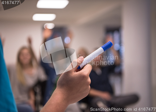 Image of close up of teacher hand with marker