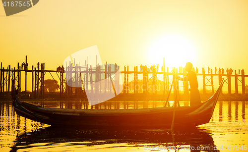 Image of Fishman under U bein bridge at sunset