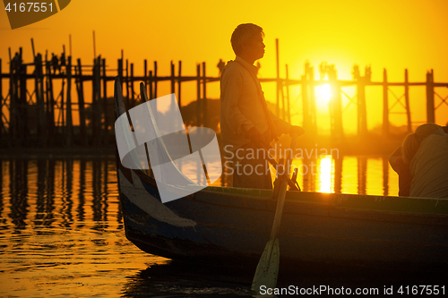 Image of Fishman under U bein bridge at sunset