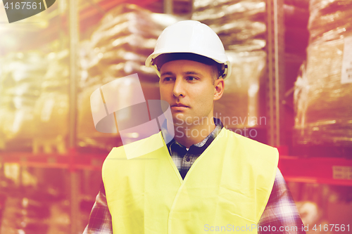 Image of man in hardhat and safety vest at warehouse