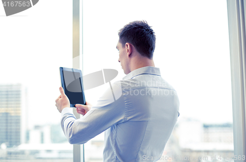 Image of businessman with tablet pc in office