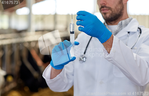 Image of veterinarian hand with vaccine in syringe on farm