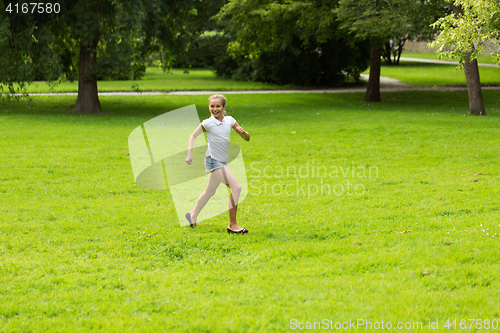 Image of happy girl running and playing at summer outdoors