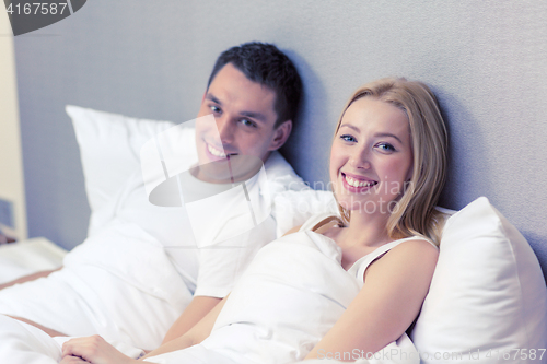 Image of happy couple sleeping in bed