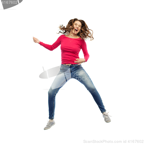 Image of happy woman jumping and pretending guitar playing