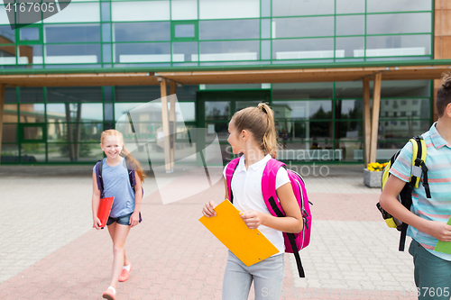 Image of happy elementary school students with folders