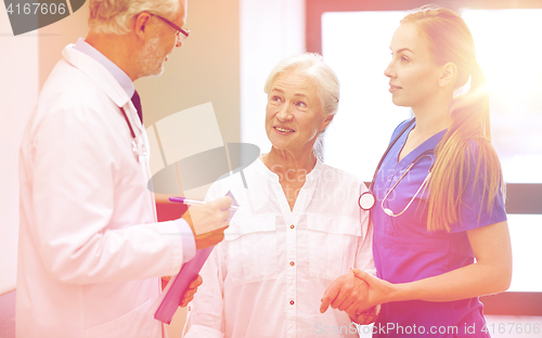 Image of medics and senior patient woman at hospital