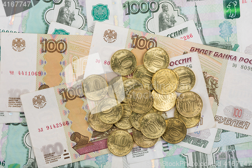 Image of On randomly scattered banknotes Russian rubles is a bunch of ten-coin