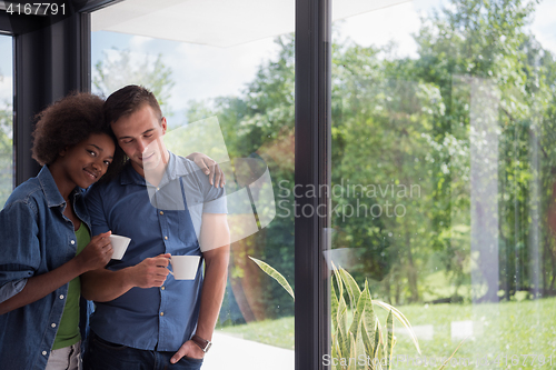 Image of romantic happy young couple relax at modern home indoors
