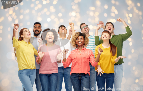 Image of international group of happy people over lights