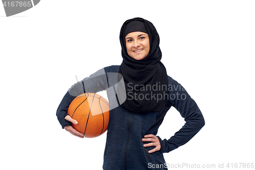 Image of happy muslim woman in hijab with basketball