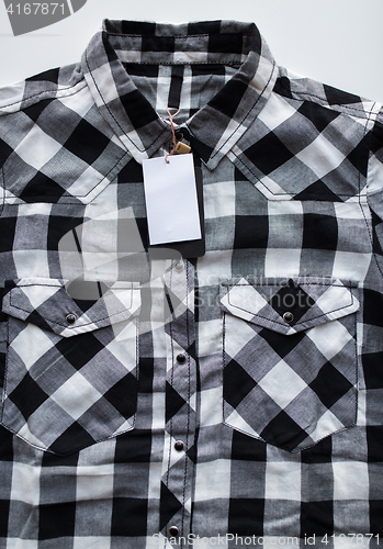 Image of close up of checkered shirt on white background