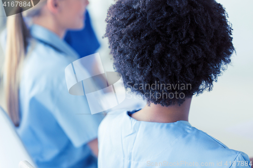 Image of close up of african doctor at hospital from back