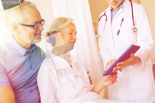 Image of senior woman and doctor with tablet pc at hospital