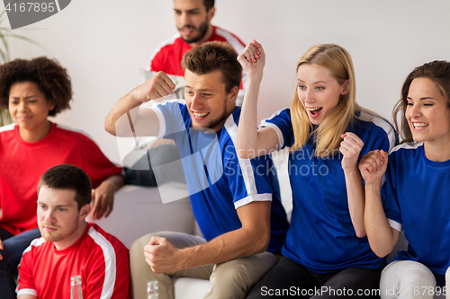 Image of friends or football fans watching soccer at home