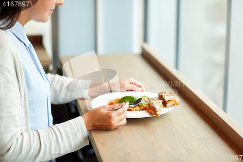 Image of woman eating gazpacho soup at restaurant