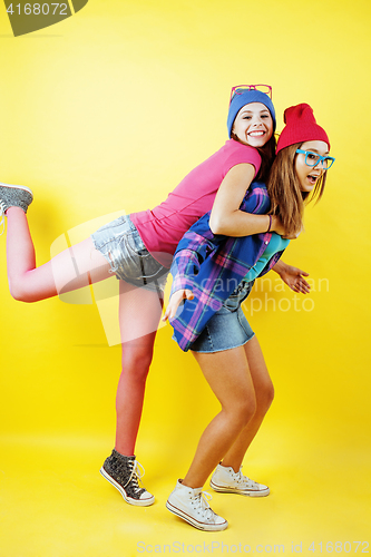 Image of lifestyle people concept: two pretty stylish modern hipster teen girl having fun together, happy smiling making selfie