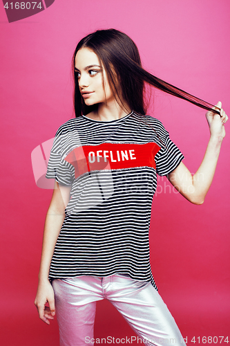 Image of young pretty teenage woman emotional posing on pink background, fashion lifestyle people concept