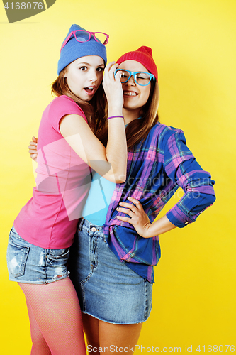 Image of lifestyle people concept: two pretty stylish modern hipster teen girl having fun together, happy smiling making selfie