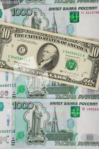 Image of Thousandths bills Russian ruble covered ten dollars