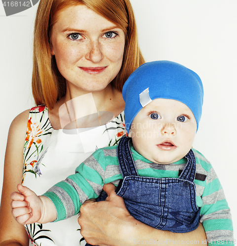 Image of young beauty mother with cute baby, red head happy modern family