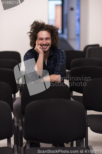 Image of A student sits alone  in a classroom