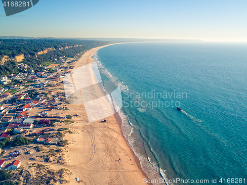 Image of Aerial View Empty Sandy Beach with Small Waves