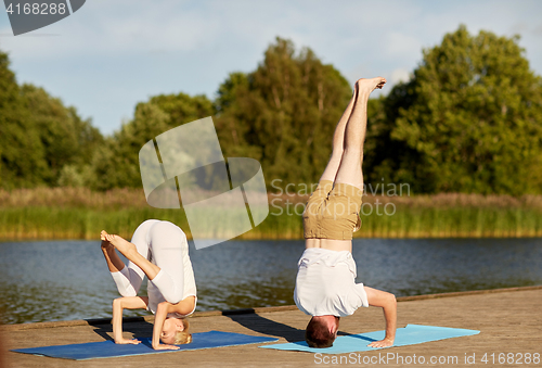 Image of couple making yoga outdoors