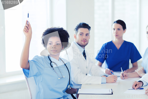 Image of group of happy doctors on conference at hospital