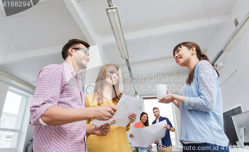 Image of creative team on coffee break talking at office