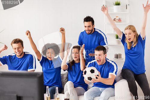 Image of friends or football fans watching soccer at home