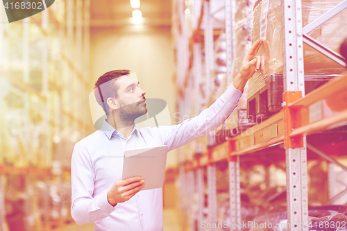 Image of businessman with tablet pc at warehouse