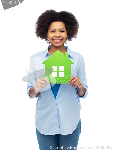 Image of happy african american woman with green house icon