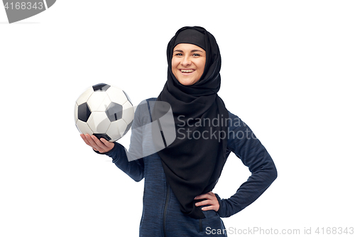 Image of happy muslim woman in hijab with football