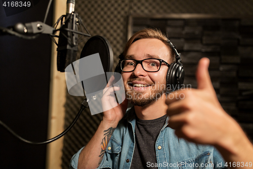 Image of man with headphones at music recording studio