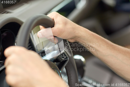 Image of close up of male hands driving car