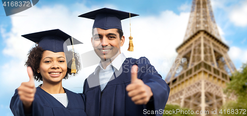 Image of bachelors showing thumbs up over eiffel tower