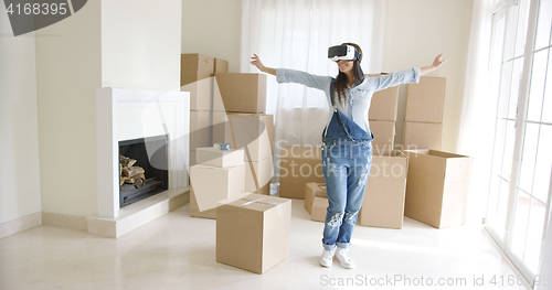 Image of Happy young woman enjoying her VR headset