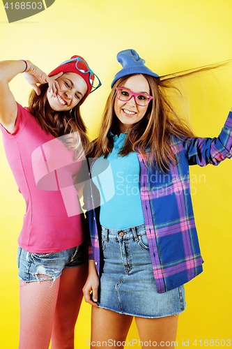 Image of lifestyle people concept: two pretty stylish modern hipster teen girl having fun together, happy smiling making selfie