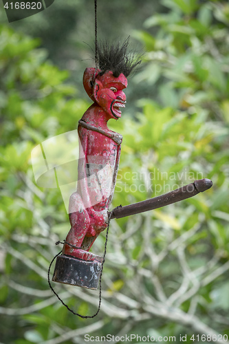 Image of Bali old wooden figure with big penis