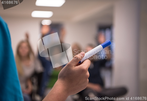 Image of close up of teacher hand with marker