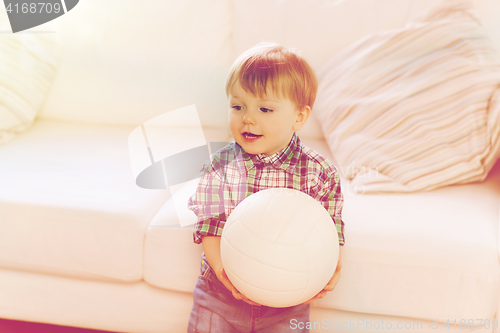 Image of happy little baby boy with ball at home