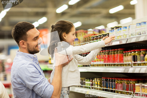 Image of father with child buying food at grocery store