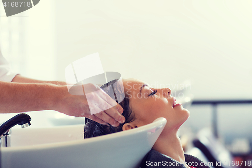 Image of happy young woman at hair salon