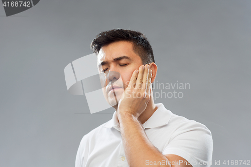 Image of unhappy man suffering toothache