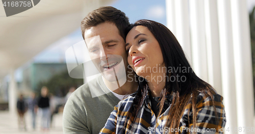 Image of Young couple relaxing at an urban waterfront