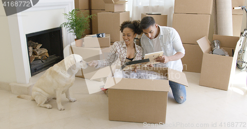 Image of Young woman petting her pet dog