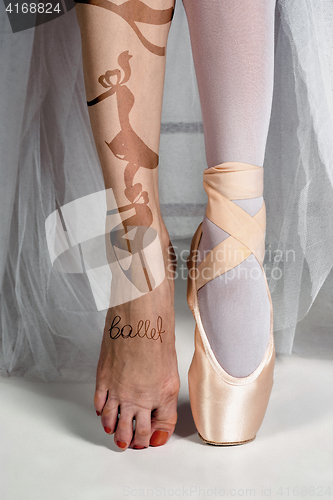 Image of The close-up feet of young ballerina in pointe shoes