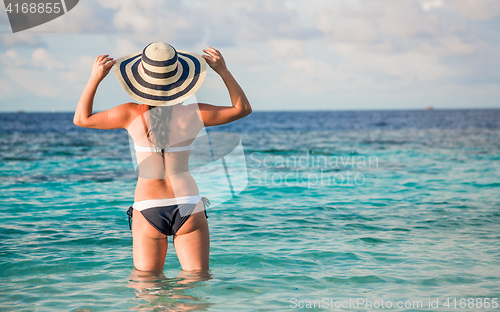 Image of Woman and tropical beach in the Maldives.